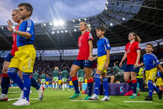 Lisa Naalsund and Signe Gaupset of Norway enter the pitch