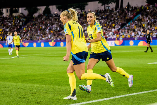 Fridolina Rolfö and Stina Blackstenius of Sweden celebrate