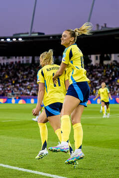 Fridolina Rolfö and Stina Blackstenius of Sweden celebrate