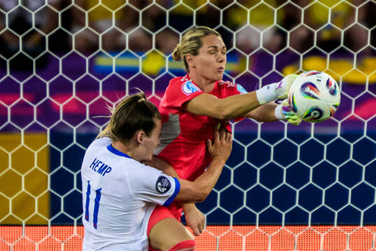 Goalkeeper Jennifer Falk of Sweden and Lauren Hemp of