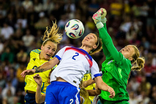 Magdalena Eriksson of Sweden and Lucy Bronze and goalkeeper