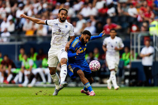Matheus Cunha of Manchester United and Jayden Bogle of