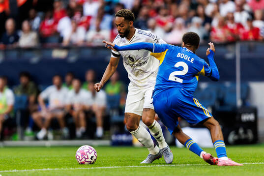 Matheus Cunha of Manchester United and Jayden Bogle of