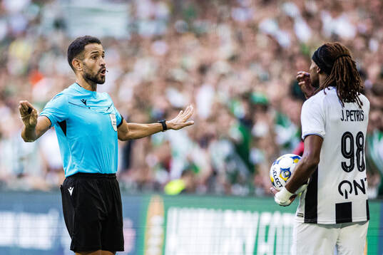 referee Mathieu Vernice and Jeremy Petris of Royal