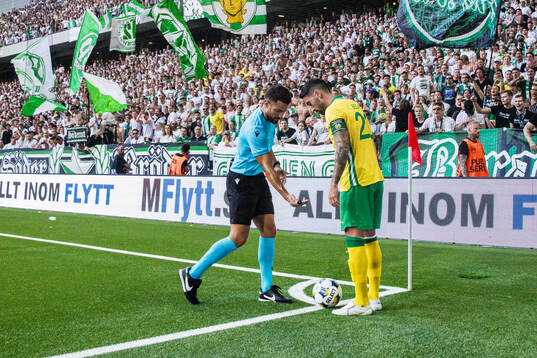 Referee Mathieu Vernice and Nahir Besara of Hammarby