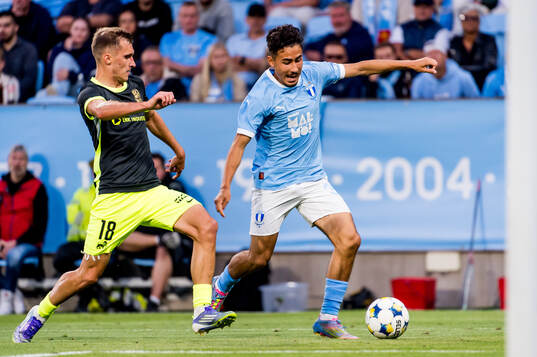 Dmitrijs Zelenkovs of FK RFS and Adrian Skogmar of Malmö FF