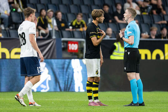 Anton Salétros of AIK speaks with referee Helgi Mikael