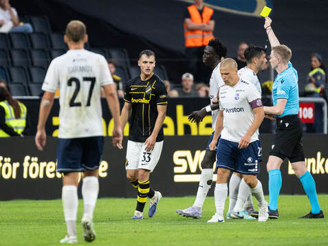 Áron Csongvai of AIK is shown a yellow card by referee