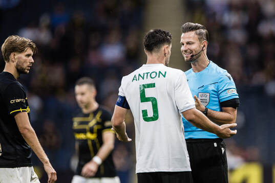 Paul Anton of Györi ETO and referee Daniel Schlager