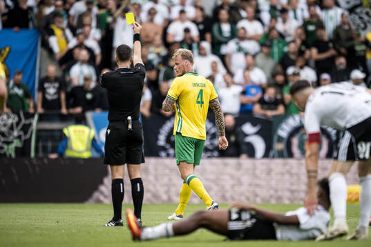 Victor Eriksson of Hammarby receives a yellow card
