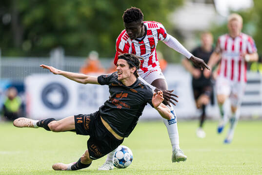 Ulrik Mathisen of Brann and Abubacarr Sedi Kinteh of Tromsø