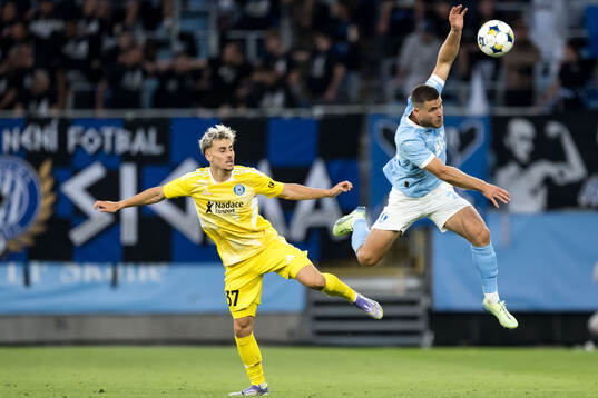 Stepan Langer of SK Sigma Olomouc and Gabriel Busanello of