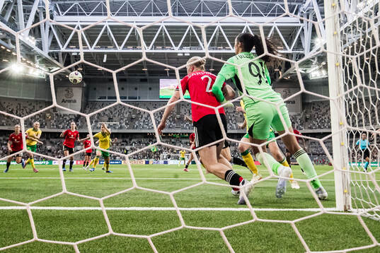 Anna Sandberg and goalkeeper Phallon Tullis-Joyce of