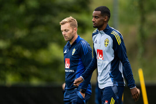 Assistant coach Sebastian Larsson and Alexander Isak of the