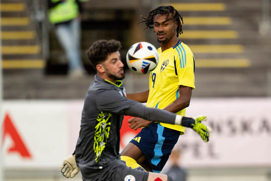 Jonah Kusi-Asare of Sweden scores 1-0 behind goalkeeper Gor