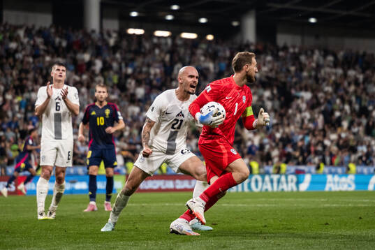 Vanja Drkusic and goalkeeper Jan Oblak of Slovenia celebrate
