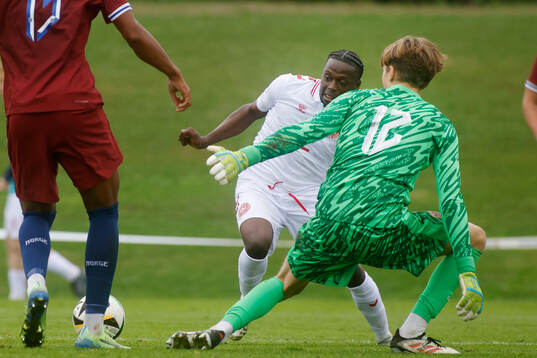 Abdul Daramy of Denmark and goalkeeper Alexander Ordal of