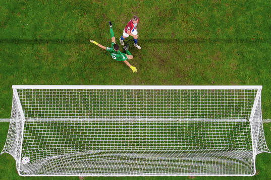 Thelo Aasgaard of Norway scores the 11-1 goal behind
