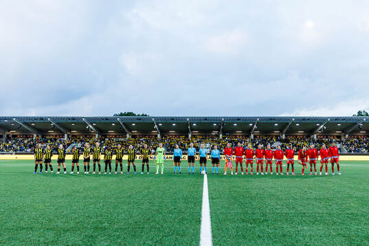 Players of Häcken and of Atletico Madrid line up