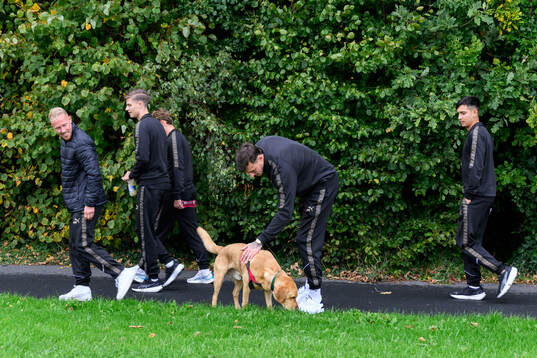 Goalkeeper Andreas Linde pets a dog