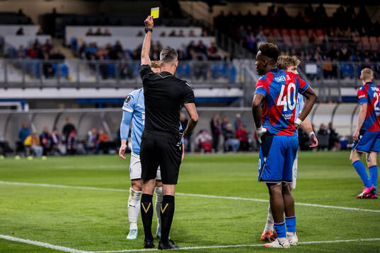 Anders Christiansen of Malmö FF receives a yellow card
