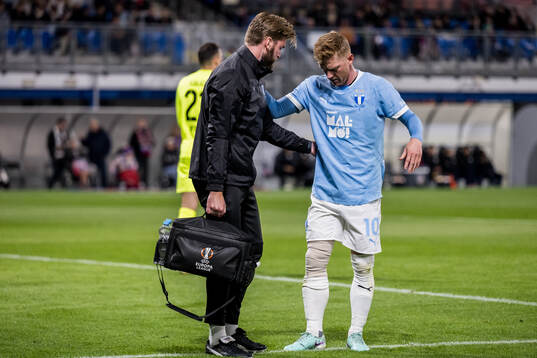 Anders Christiansen of Malmö FF receives medical attention
