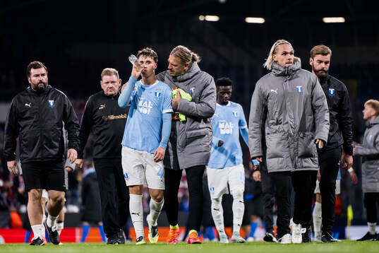Kenan Busuladzic and Goalkeeper Johan Dahlin of Malmö FF