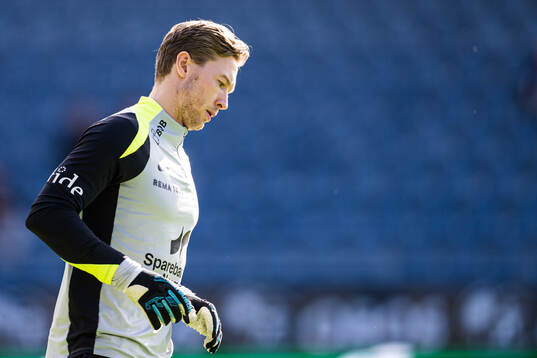 Goalkeeper Mathias Dyngeland of Brann warms up