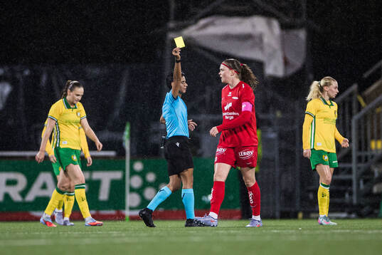 Signe Gaupset of Brann receives a yellow card from referee