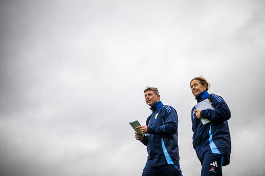Head coach Jon Dahl Tomasson and media officer Petra