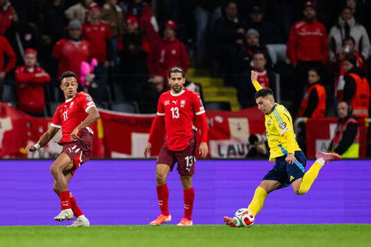 Dan Ndoye and Ricardo Rodriguez of Switzerland and Roony