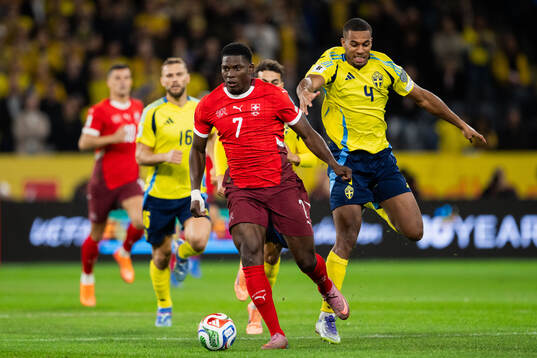 Breel Embolo of Switzerland and Isak Hien of Sweden