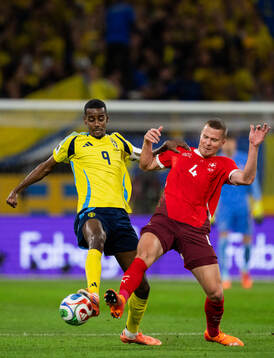 Alexander Isak of Sweden and Nico Elvedi of Switzerland