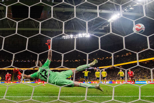 Goalkeeper Viktor Johansson of Sweden when Granit Xhaka of