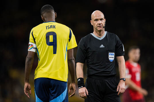Alexander Isak of Sweden and Referee Anthony Taylor