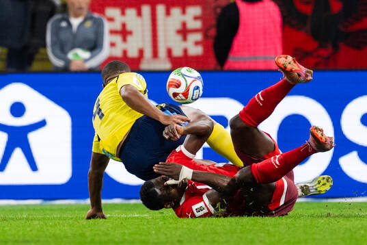 Isak Hien of Sweden and Breel Embolo of Switzerland