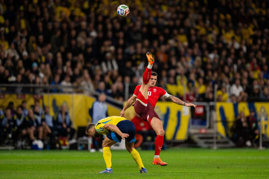 Jesper Karlström of Sweden and Granit Xhaka of Switzerland