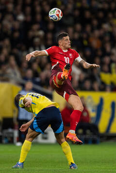 Jesper Karlström of Sweden and Granit Xhaka of Switzerland