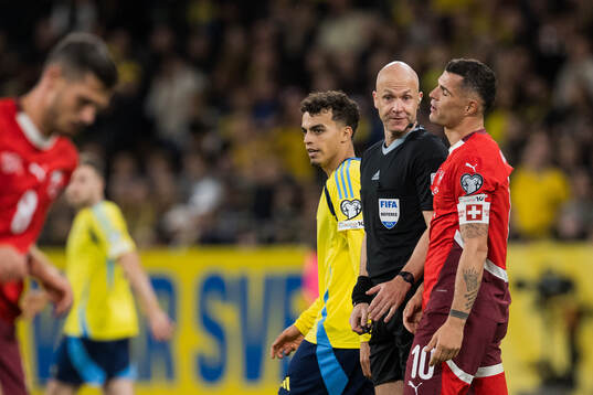Yasin Ayari of Sweden, Referee Anthony Taylor and Granit