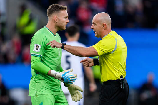 goalkeeper Daniel Peretz of Israel and Referee Szymon