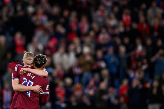 Erling Braut Haaland celebrates with Antonio Nusa of Norway