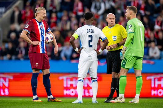 Erling Braut Haaland of Norway, Eli Dasa of Israel, referee