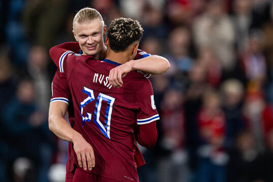 Erling Braut Haaland celebrates with Antonio Nusa of Norway