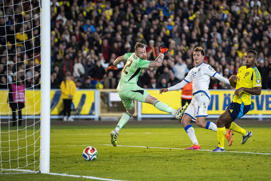 Fisnik Asllani of Kosovo scores the 0-1 goal behind