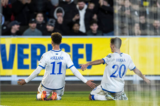 Fisnik Asllani and Veldin Hodža of Kosovo celebrate the