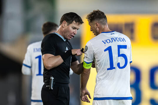 Referee Danny Makkelie and Mergim Vojvoda of Kosovo