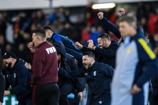 Team Kosovo celebrates behind Head coach Jon Dahl Tomasson