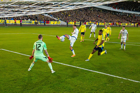 Fisnik Asllani of Kosovo scores 0-1 behind goalkeeper