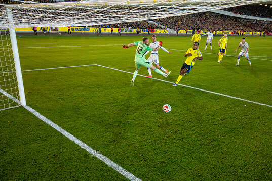 Fisnik Asllani of Kosovo scores 0-1 behind goalkeeper