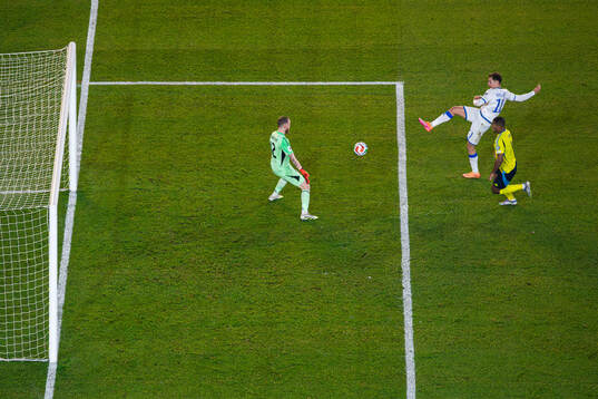 Fisnik Asllani of Kosovo scores 0-1 behind goalkeeper